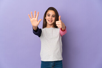 Little girl isolated on purple background counting six with fingers