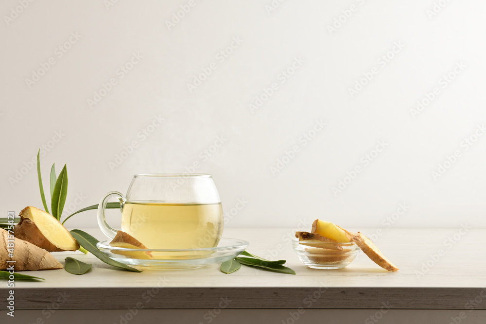 Wall mural Ginger beverage on table with ginger root white isolated background