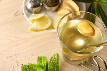 Green tea with ginger on wooden table elevated detail