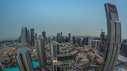 Aerial panoramic view of a big futuristic city day to night timelapse. Business bay and Downtown