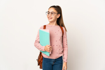 Fototapeta premium Little student girl over isolated background thinking an idea while looking up