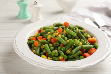 Mix of fresh vegetables served on white wooden table