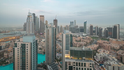 Obraz premium Aerial view of a big futuristic city day to night timelapse. Business bay and Downtown