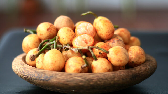 Menteng fruit or Baccaurea racemosa on wood plate. 