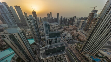 Aerial panoramic sunrise over big futuristic city all day timelapse. Business bay and Downtown