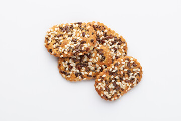 Tasty crackers with seeds on the white background.