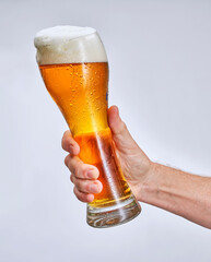 hand holding glass of beer