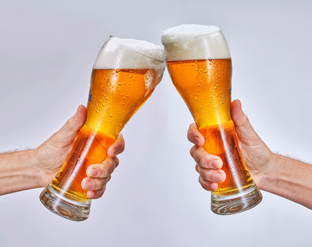 hand holding glass of beer