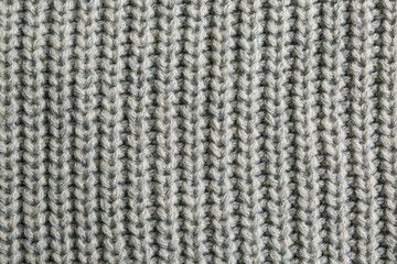 Beautiful grey knitted fabric as background, top view