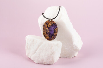 Decoration handmade lilac pendant made of stabilized wood on a granite stone stand