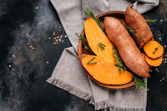 Organic orange sweet potato. Raw sweet potatoes or batatas. vegan food ingredient. banner, menu, recipe place for text, top view
