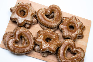 Gingerbread cookies hart and star-shaped on wooden board