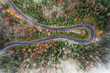Serpentine roads in Ukraine, fog in the mountains, serpentine road in the fog, drove on top of the road.