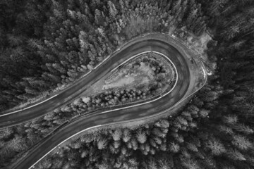 Obraz premium Picturesque mountains and serpentine roads, forest and road in the fog, steep turns of roads, road in the mountains.