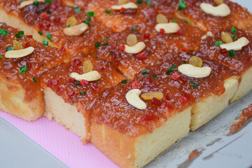 Sponge cake topped with marmalade and cashew nuts
