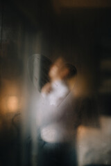 blurred silhouette of dressing man