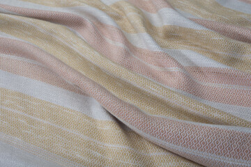 Close up of texture of hand woven plaid shawl, Thai cotton wood bark dyed
