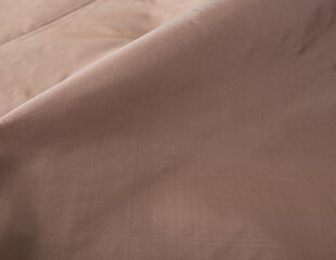 Close up of texture of hand woven Thai silk in earth tone color