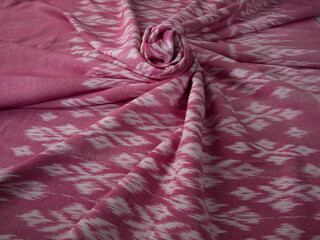 Close up of texture of pink color hand woven cotton fabric, Thai cotton natural color dyed