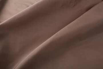 Close up of texture of hand woven Thai silk in earth tone color