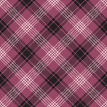 Pink and black argyle tartan plaid. Scottish pattern fabric swatch close-up. 