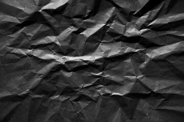 Abstract black crumpled paper texture background.