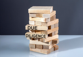 The text on the wooden blocks DUE DILIGENCE