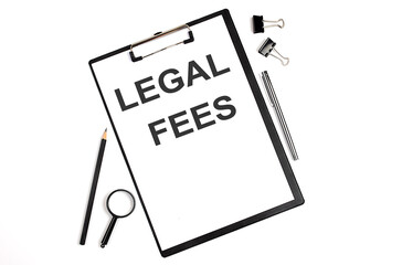 On a white background magnifier, a pen and a sheet of paper with the text LEGAL FEES . Business concept
