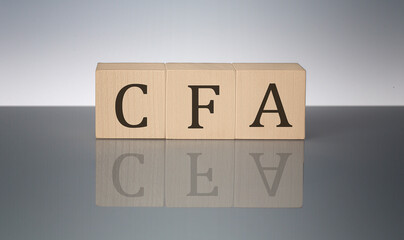 CFA concept, wooden word block on the grey background
