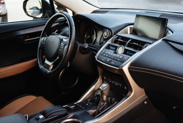 Fototapeta na wymiar Modern luxury car Interior - steering wheel, shift lever and dashboard. Car interior luxury inside. Steering wheel, dashboard, speedometer, display.Yellow leather interior.