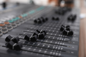 Professional mixing console on table in modern radio studio, closeup