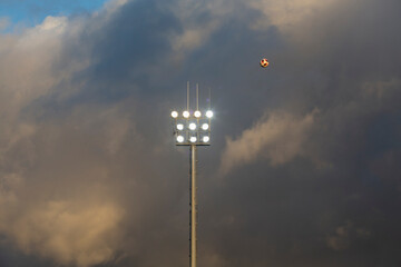 Lighting of a soccer field with storm clouds in the background