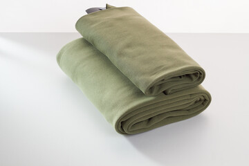 Rolls of bright colored fabric on a white background.