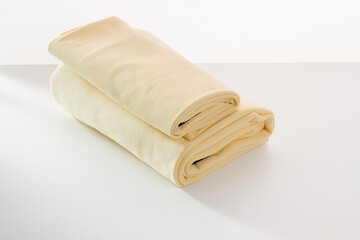 Rolls of bright colored fabric on a white background.