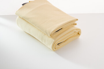 Rolls of bright colored fabric on a white background.