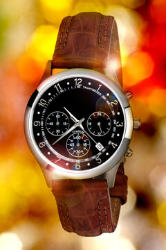 wristwatch for man on color lights background