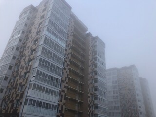 Heavy morning fog and evaporation in the city with high-rise buildings