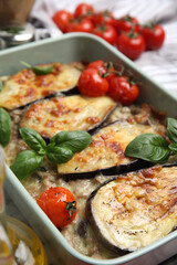 Delicious eggplant lasagna in baking dish on table, closeup