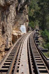 Fototapeta na wymiar Tracks of Thai Burma Railway (Death Railway) near River Kwae Noi (vertical image), Kanchanaburi, Thailand