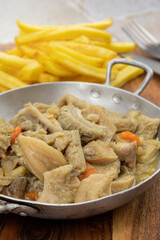 dish of tripe and fries on a table