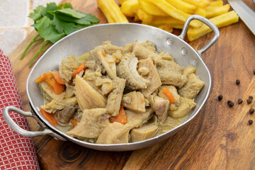 dish of tripe and fries on a table