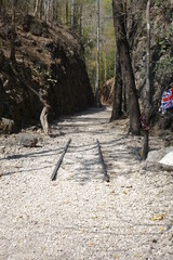 Remains of old railway track of Thai Burma Railway (Death Railway) with a Union Jack attached to...