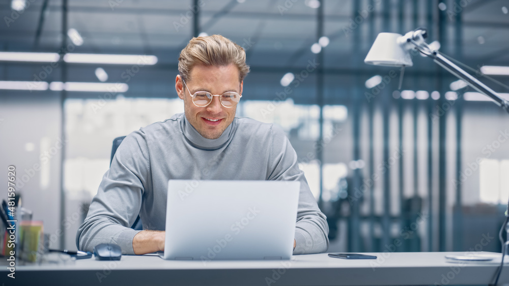 Poster Modern Modern Office: Businessman Sitting at His Desk Working on a Laptop Computer. Digital Entrepreneur working with Big Data e-Commerce Project, Successful Startup. Blurred Background.