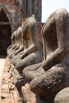 Line of headless statues at  Wat Chai Watthanaram temple, Ayutthaya, Thailand (vertical image)