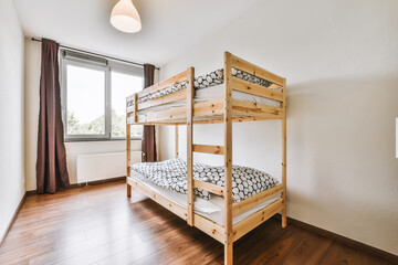 Lovely bedroom with wooden bunk bed and chandelier - obrazy, fototapety, plakaty