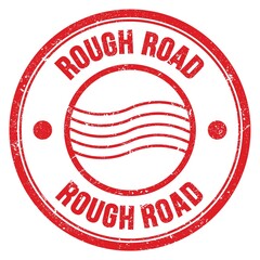 ROUGH ROAD text written on red round postal stamp sign