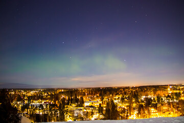 Aurora borealis and a town by night