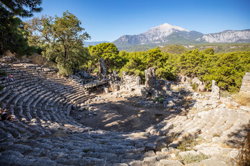 Ruins of the aqueduct of the ancient ancient city of Phaselis illuminated by the bright sun in Pine forest, woods in sunny weather in Turkey, Antalya, Kemer. Turkey national nature landmarks.