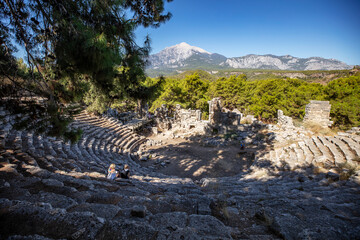 Obraz na płótnie Canvas Ruins of the aqueduct of the ancient ancient city of Phaselis illuminated by the bright sun in Pine forest, woods in sunny weather in Turkey, Antalya, Kemer. Turkey national nature landmarks.