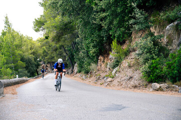Cyclist preparing to take a turn on a mountain road with a road bike